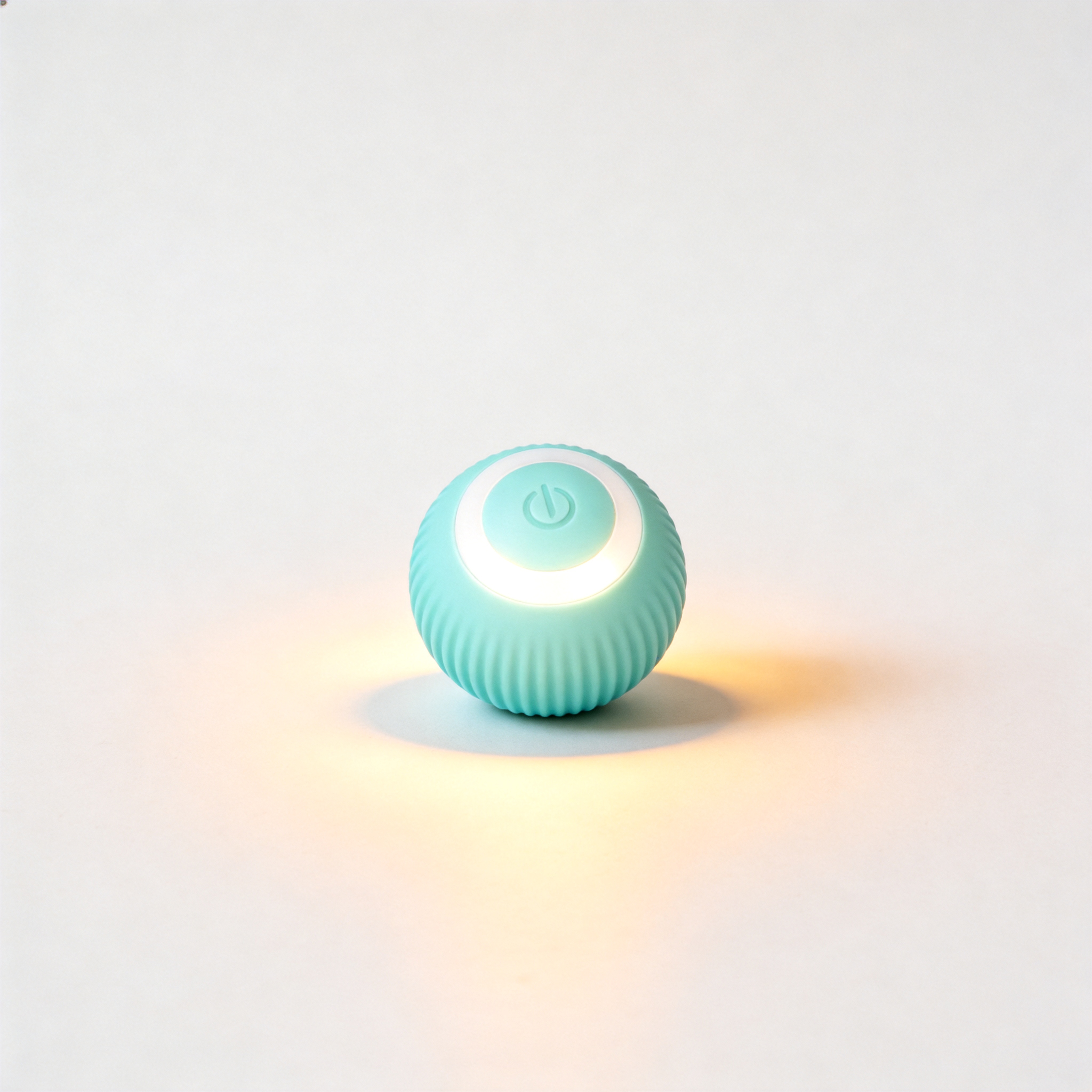 The teal Pounce smart ball with its glowing LED ring